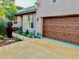 Entrance after, with stained driveway and new landscaping
