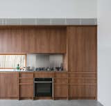 Kitchen, Metal Counter, Laminate Cabinet, Wall Oven, Ceiling Lighting, Cooktops, Metal Backsplashe, Concrete Floor, Refrigerator, Undermount Sink, and Wood Cabinet  Photo 10 of 27 in Silver Back by Lauren Chiefari