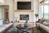 Living Room, Sofa, Wood Burning Fireplace, Ceiling Lighting, Coffee Tables, Porcelain Tile Floor, and Standard Layout Fireplace  Photo 2 of 13 in Whispering Woods by Courtney Banner
