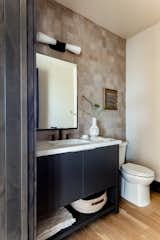 Bath Room, Engineered Quartz Counter, Ceramic Tile Wall, Drop In Sink, Light Hardwood Floor, One Piece Toilet, and Wall Lighting Powder Bathroom  Photo 10 of 13 in Peak Place by Courtney Banner