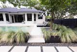Plunge pool in Austin, TX surrounded by feathery, low-water grasses and contrasting pavers 