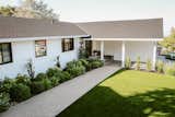 Outdoor, Flowers, Grass, Shrubs, Decomposed Granite Patio, Porch, Deck, Hardscapes, and Front Yard Green and white shrubs and flowers line the walkway and artificial turf front lawn   Photo 4 of 9 in Burlingame Modern Farmhouse Rancher by Yardzen