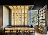 Dining Room, Wall Lighting, Shelves, Bar, Stools, and Light Hardwood Floor Overscale Chinese abacus styled partition  Photo 1 of 14 in Mala Sichuan M-K-T Houston by MIMI PR