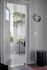 Bath Room, Marble Counter, Terrazzo Floor, Vessel Sink, and Ceiling Lighting The bathroom was conceived as a limbo-environment deliberately disconnected from the rest of the house on a stylistic level. Characterized by marble grit coverings, opaque black taps and by the large shower with an arched entrance, a space for meditation and relaxation. The atmosphere is completed by the intense presence of plants to create a small urban jungle in the heart of the city.

Floor and shower coverings by Mariotti Fulget
Fabula Stories shelves  Photo 17 of 20 in Fabula's house by Vania Viscardi