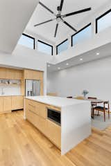 Upper floor living space. Plywood kitchen island cabinetry below clerestory.