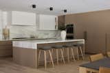 A modern kitchen with a large island for communal gathering and entertaining.