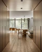 A passthrough pantry clad in wood that maximizes storage and acts as an entryway into the heart of the home.