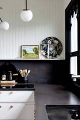 Black & White modern kitchen with beadboard accent and modern accessories
