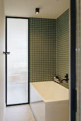 Bath Room, Tile Counter, Drop In Tub, Corner Shower, Open Shower, Mosaic Tile Wall, Concrete Floor, and Ceiling Lighting This small bathroom needed to be as precise as possible, so you don't lose space.  Photo 1 of 4 in The box by Standard Studio Hello