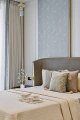 Neutral and sombre swatches mollify the tone of the bedroom design. From roasted browns to taupe, the upholstery balances the minimalistic theme with subtle highlights of brass. The three-toned bedrooms are etched on the narrative of natural and soft furnishings, patterns, prints, polished veneers, and enveloped with marble flooring. The soft touch of greys pacifies the wooden furniture, and the tranquil setting allows nature to flow within the large openings, adding freshness to the bedrooms.
