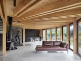 Living Room, Sofa, Concrete Floor, Wood Burning Fireplace, and Ceiling Lighting  Photo 10 of 25 in House That Opens Up to the Sun by Stempel Tesar architects