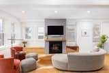 Living Room, Gas Burning Fireplace, Light Hardwood Floor, Recessed Lighting, Ceiling Lighting, Ottomans, Coffee Tables, and Sofa  Photo 3 of 14 in Humboldt St. Modern Home Remodel by Factor Design Build