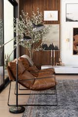 Living Room, Media Cabinet, Floor Lighting, Rug Floor, Vinyl Floor, Wall Lighting, Light Hardwood Floor, Lamps, and Chair Living Room Media/Art Gallery  Photo 1 of 10 in Contemporary Casa