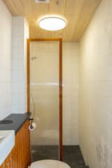 Bathroom with pine tounge and groove ceiling and custom vanity and shower screen