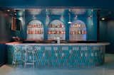 Bar.
- Custom soffit with water metal ripple, Geneva model by G-Tex (UK)
- Wall: silver micro-cement by Ciment Art
- Counter: Calathea tile by Acquario Due (Italy)
- Counter top: Mediterranean Blue marble by ABC Stone
- Lights: N55 by Viabizzuno
- Stools: Master by Kartell