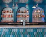 Bar.
- Custom soffit with water metal ripple, Geneva model by G-Tex (UK)
- Wall: silver micro-cement by Ciment Art
- Counter: Calathea tile by Acquario Due (Italy)
- Counter top: Mediterranean Blue marble by ABC Stone
- Lights: N55 by Viabizzuno