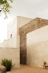 Strong entrance to the home includes 20 foot walls softened by the hand laid  stone taking from the property during the construction 