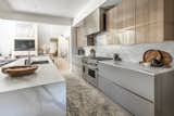 Kitchen, Wood Cabinet, Marble Counter, Wall Oven, Cooktops, Marble Backsplashe, and Dishwasher  Photo 4 of 7 in Mountain Modern Masterpiece by Marisol Rocha
