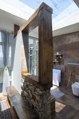 Reclaimed wooden frame divides the closet and the rustic washroom.