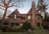 Exterior, Hipped RoofLine, Brick Siding Material, House Building Type, and Shingles Roof Material Exterior from sideyard  Photo 7 of 10 in Tudor House Renovation by Ariadna