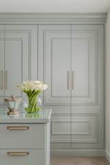 Details of hardware and custom millwork on doors of wardrobe. 