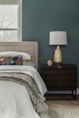 Textured nightstands with storage paired with a glossy and bright table lamp. 
