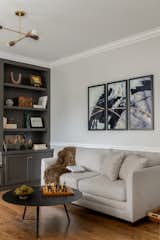 A sleeper sofa sits on the other side of the office space for guests to spend the night comfortably.