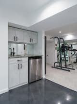 Basement home gym with built-in wet bar.
