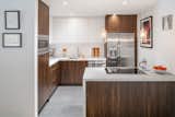 Kitchen, Wood Cabinet, Pendant Lighting, Porcelain Tile Floor, Microwave, Dishwasher, Refrigerator, Mosaic Tile Backsplashe, Ceiling Lighting, White Cabinet, Cooktops, Recessed Lighting, Undermount Sink, and Quartzite Counter  Photo 4 of 6 in WH30 - Interior Remodel by F-ARE 
