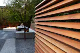 A custom automatic gate opens to reveal the garden
