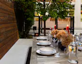Dinner is set. The custom automatic gate provides security and private from the busy city street.