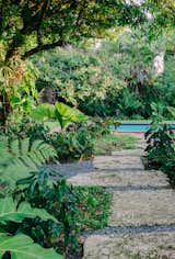 The design bled into the landscaping with direction from landscape designer Overland. The lush, tropical foliage is creates nooks for a quiet swing seat overlooking the pool, fire pits for cold Miami nights, al fresco dining for 8 person, and other hidden nooks sprinkled throughout the property. 