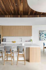 Kitchen, Undermount Sink, Ceramic Tile Floor, Wall Oven, Stone Counter, Wood Cabinet, White Cabinet, and Stone Slab Backsplashe Newport Houses - House 2  Photo 3 of 19 in Newport Houses by Kiri Sawtell