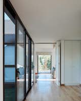 Hallway and Light Hardwood Floor Entrance hall, view to the TV Room  Photo 9 of 27 in Casa MFQ by ND Estudio