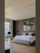 Bedroom, Light Hardwood Floor, Pendant Lighting, Chair, Bed, and Wardrobe  Photo 8 of 12 in Bosques Apartment by Taller David Dana