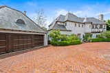 Exterior, Tile Roof Material, Stucco Siding Material, and House Building Type A Steeply Pitched Slate-Clad Roof with Steeple-Like Finials, Round Towers and Decorative Half-Timbering  Photo 2 of 13 in French Normandy Revival Estate In Coveted Enclave of Beverly Hills Lists for $8.5M by Beyond Shelter