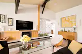Soaring ceilings and an original breeze block raised hearth planter are focal points in the living room.