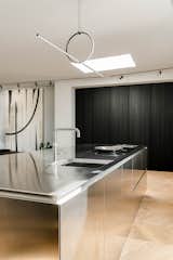 Kitchen, Cooktops, Wood Cabinet, Light Hardwood Floor, Metal Counter, Dishwasher, Ceiling Lighting, and Pendant Lighting Kitchen   Photo 1 of 15 in S_04 by HAA&D