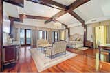 Massive bedroom with wood beams, gorgeous hardwoods and outdoor access seating area