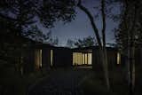 As dusk falls, The Perch glows from within, its strategic lighting emphasizing the interplay of solid and void.