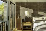 The private suite is a serene retreat, where a subdued palette and natural textures create a calming atmosphere. 