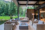 The architecture is broken into two distinct volumes—guest and primary wings—connected by a covered outdoor deck that amplifies the indoor-outdoor experience.