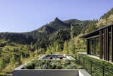 Net-zero energy is achieved through geothermal systems, photovoltaic panels, and highly efficient building envelopes.