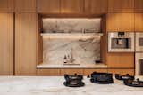 Kitchen, Dishwasher, Marble Counter, Refrigerator, Range, Wine Cooler, Microwave, Beverage Center, Cooktops, Marble Backsplashe, Wood Cabinet, Undermount Sink, and Wall Oven Kitchen  Photo 10 of 30 in Historic Canal Home in Amsterdam by Amy Deutcher