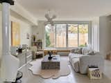 Living Room, Accent Lighting, Coffee Tables, Bench, Hanging Fireplace, Concrete Floor, Wood Burning Fireplace, Bookcase, Chair, and Sofa  Photo 9 of 17 in Osborne Laneway Suite by Lanescape Architecture Inc.