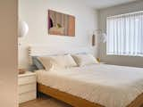 Bedroom, Medium Hardwood Floor, Bed, and Wall Lighting  Photo 16 of 17 in Osborne Laneway Suite by Lanescape Architecture Inc.