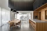 Kitchen, Concrete Counter, Mirror Backsplashe, Concrete Floor, Beverage Center, Pendant Lighting, Ceiling Lighting, Wood Cabinet, Cooktops, Undermount Sink, Wall Lighting, Range Hood, Recessed Lighting, Refrigerator, and Wall Oven  Photo 4 of 6 in Sanctum // House on the Hill by Jo Churchill