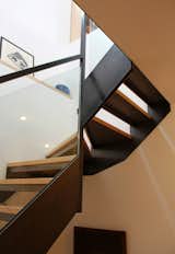Staircase, Glass Railing, Metal Railing, and Wood Tread Detail at winders.  Photo 8 of 8 in Steel and Glass Stair by Leo Mieles