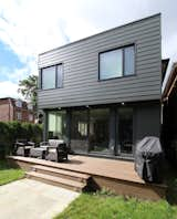 Exterior, House Building Type, Flat RoofLine, and Concrete Siding Material View from Yard  Photo 5 of 5 in House Addition in Dufferin Grove by Leo Mieles