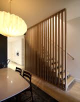 The main stair features vertical wooden white oak slats.